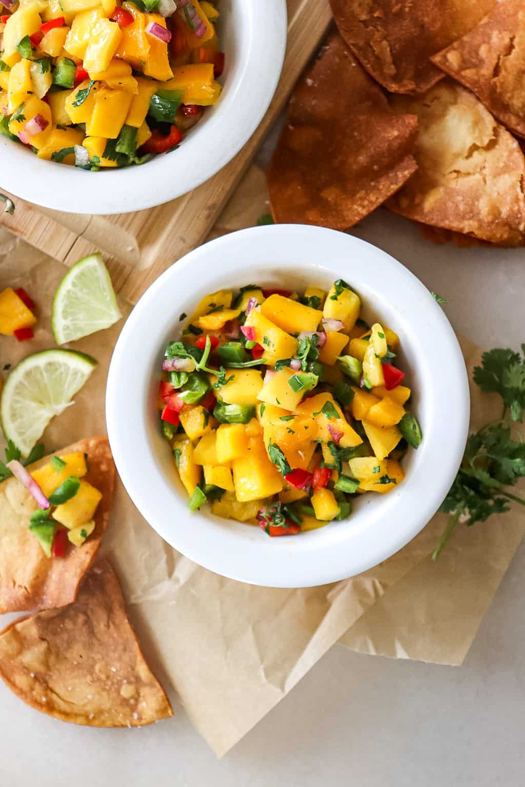 a bowl of mango salsa with homemade tortilla chips next to it