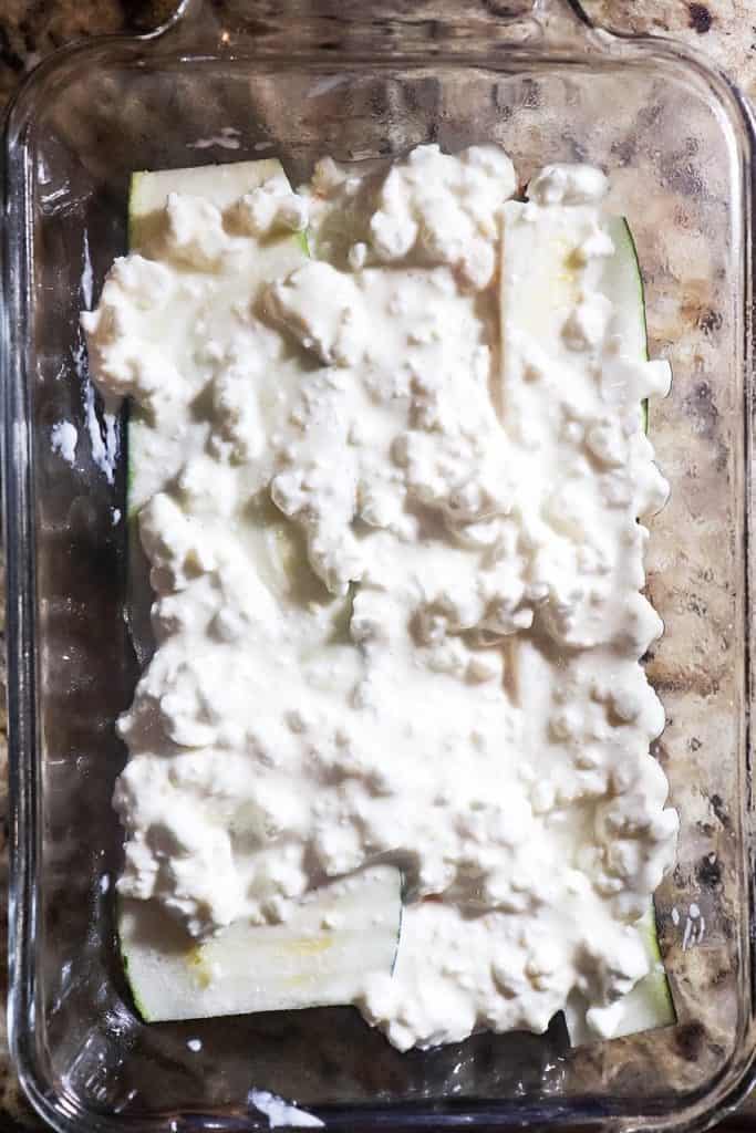 picture of layering cottage cheese in dish for zucchini lasagna