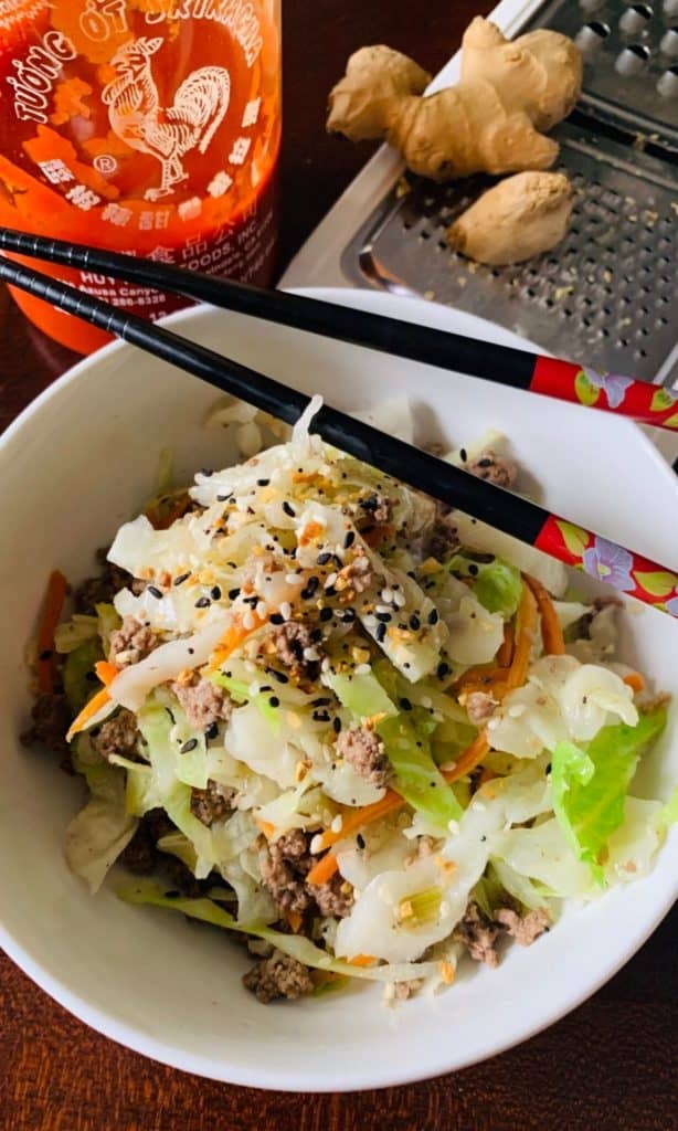 keto egg roll in a bowl with chopsticks placed over top