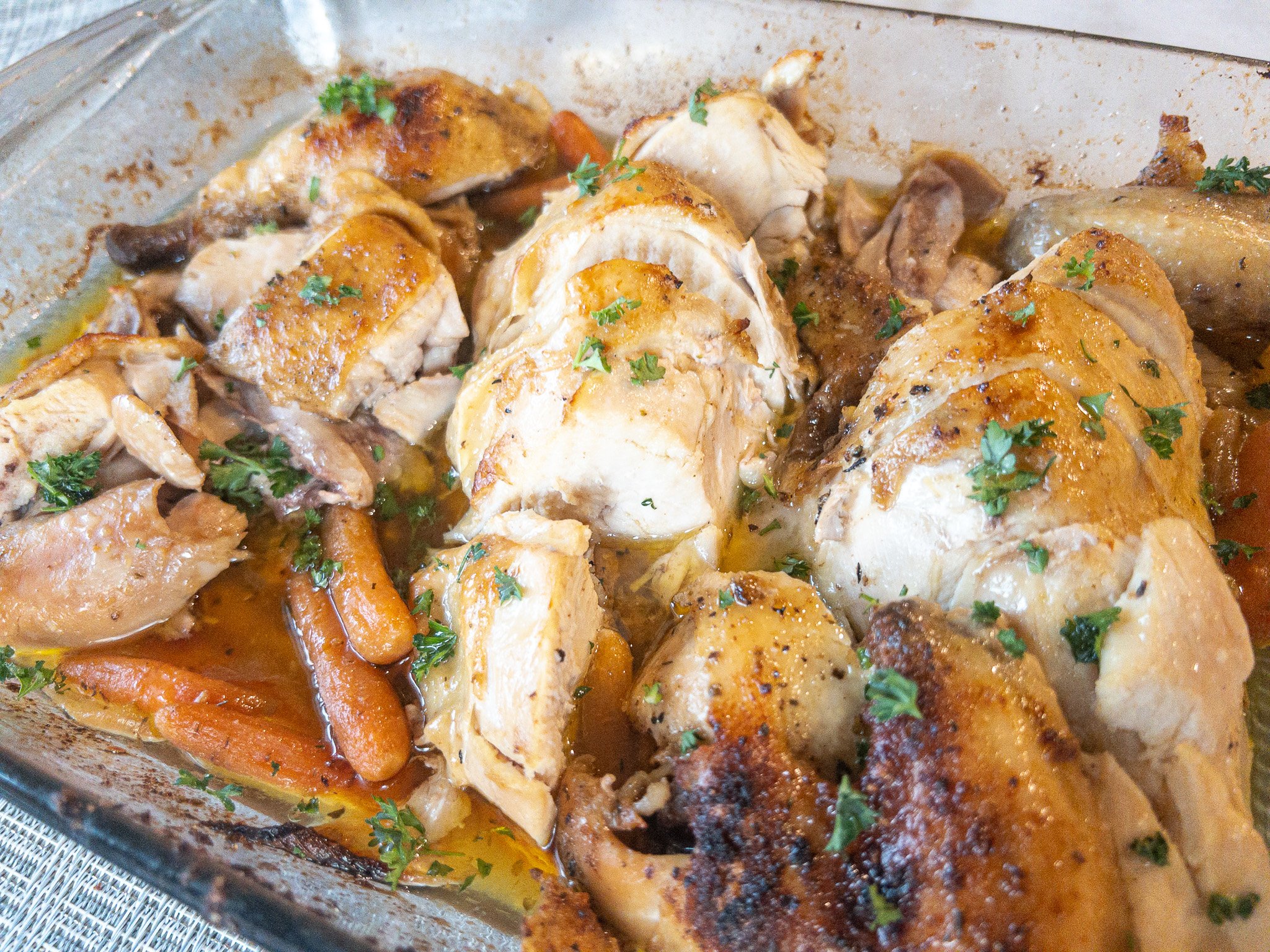 chicken that has been roasted and sliced in a baking dish