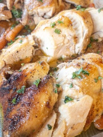 oven roasted chicken in a baking dish cut into portions