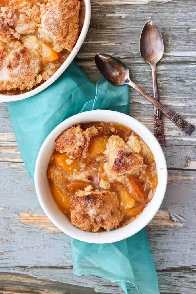 Overhead view of a bowl of peach cobbler