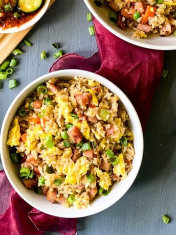 pork fried rice in a bowl with a red napkin underneath it