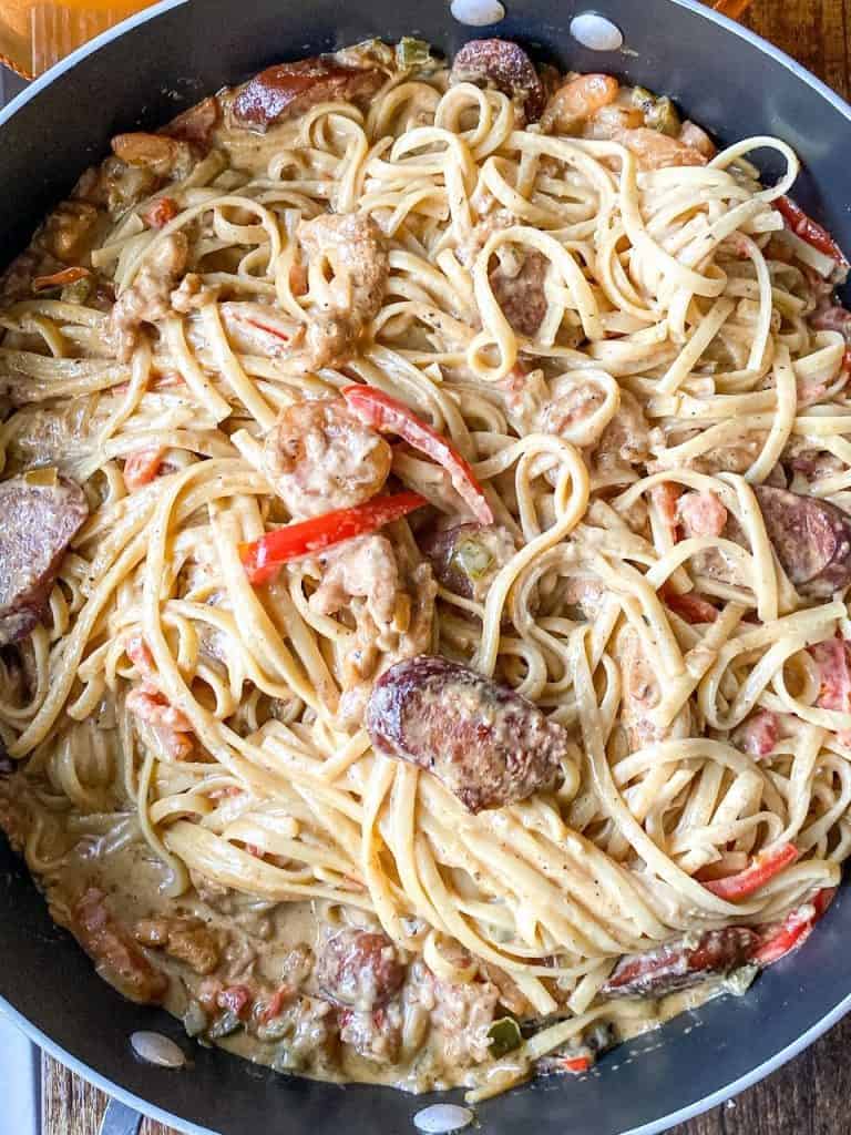 Creamy Rasta Pasta with Smoked Sausage and Chicken shown above head in the pan