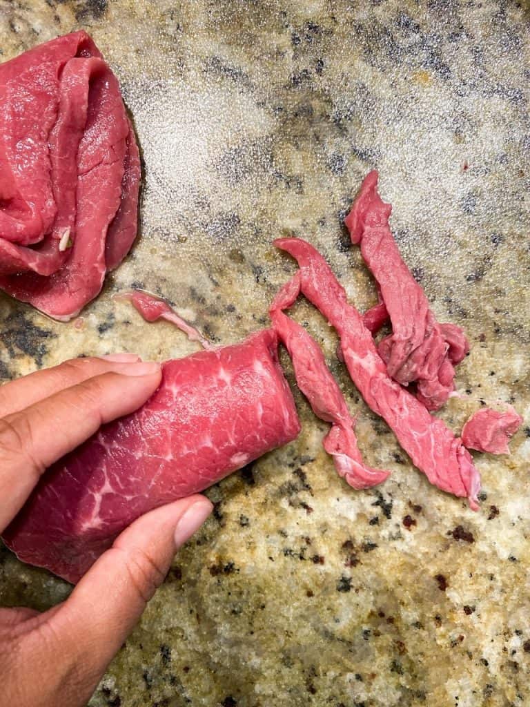 cutting up beef for beef bulgolgi