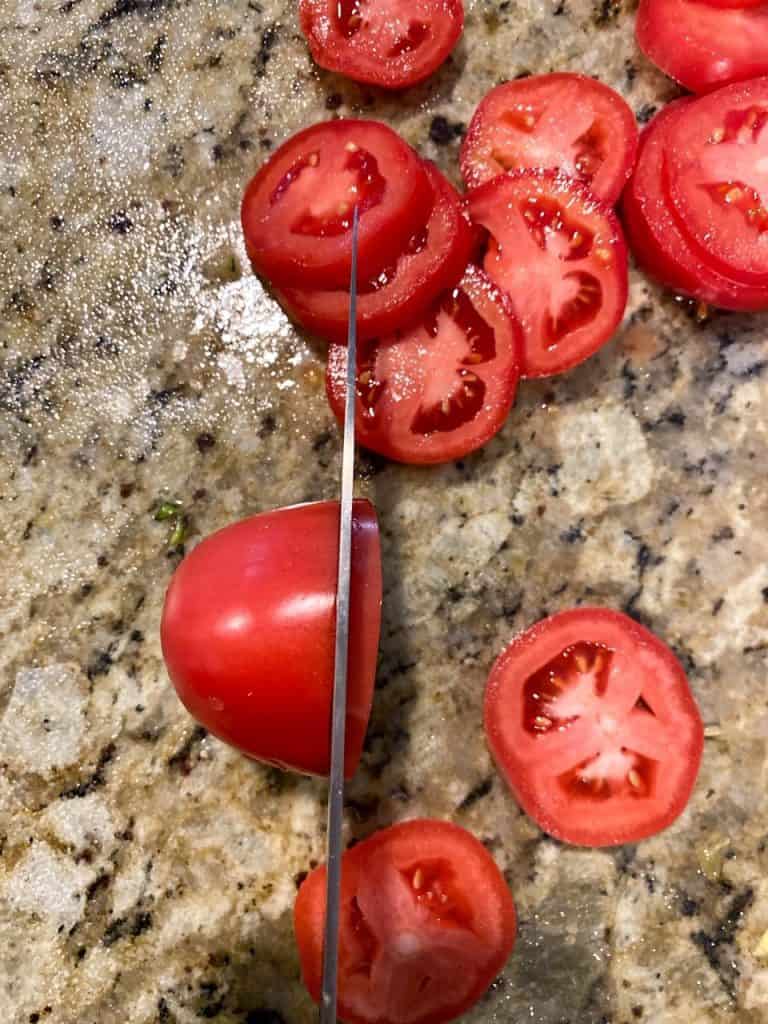 thinly slicing tomatoes