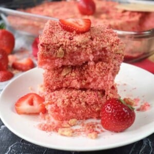 strawberry crunch cake brownies stacked on a plate