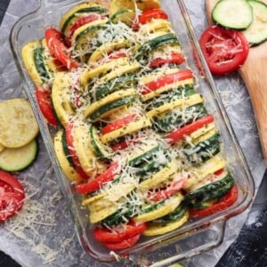 squash and tomatoes cooked in a baking dish with parmesan cheese on top