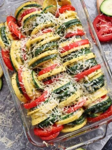 squash and tomatoes cooked in a baking dish with parmesan cheese on top