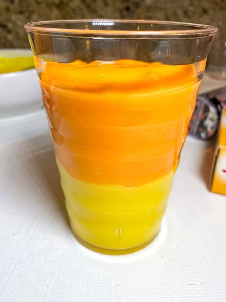 yellow and orange vanilla pudding layered in a cup