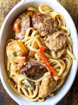 a dish full of rasta pasta with chicken, shrimp, and sausage
