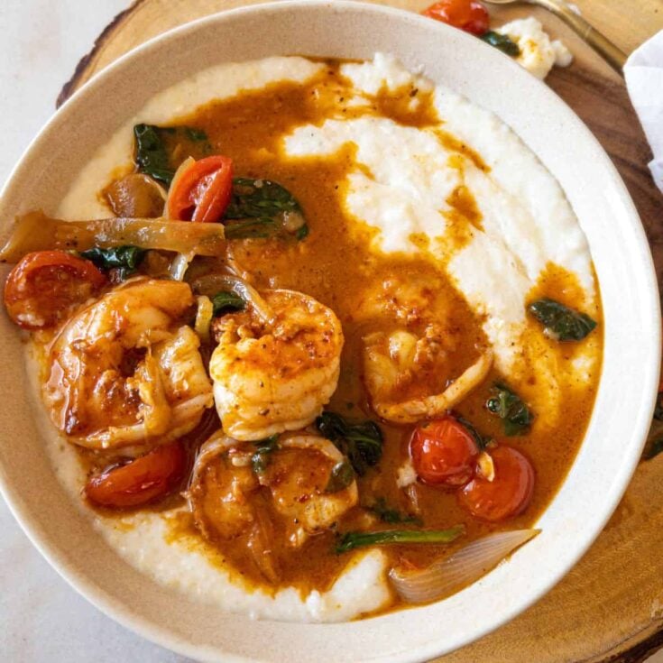 bowl of shrimp and grits with a garlic butter sauce