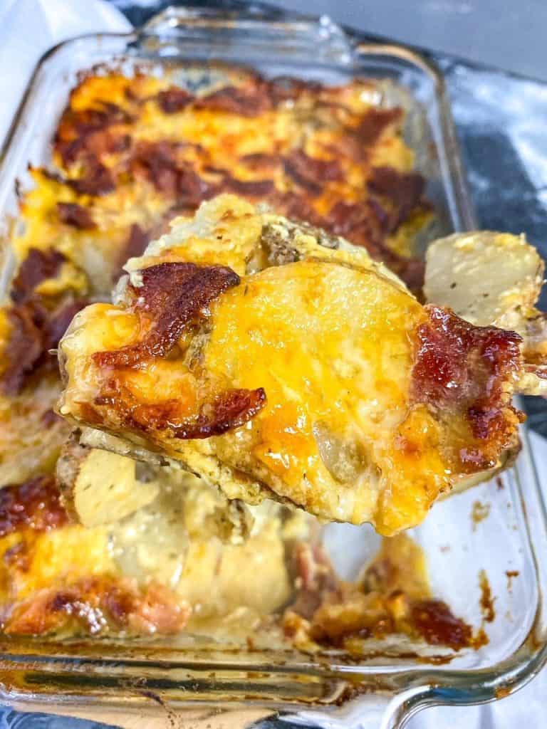 a scoop of Cheesy Bacon Ranch Scalloped Potatoes