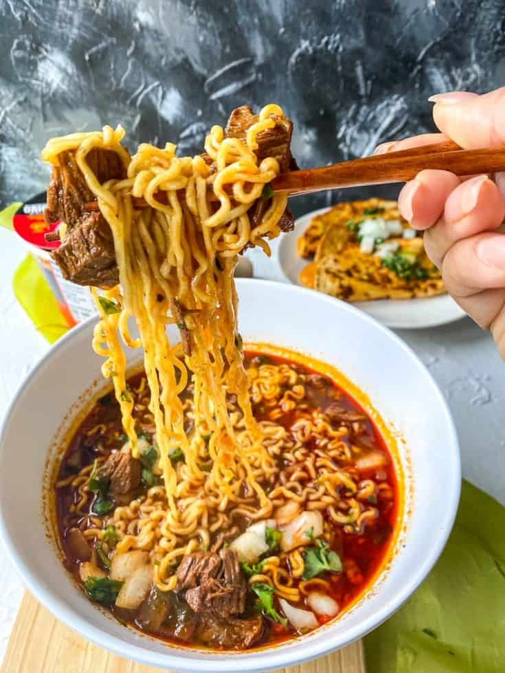 noodle pull of birria ramen wiht beef