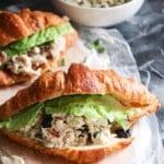 turkey salad on croissants with a piece of lettuce as garnish