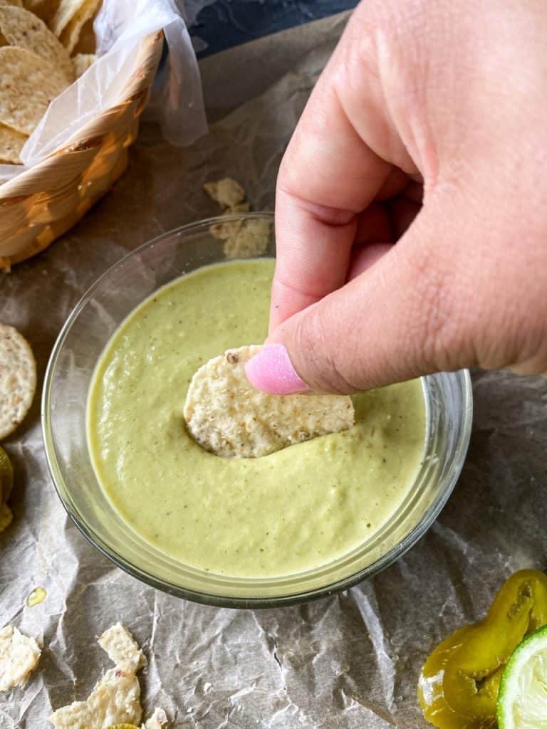 dipping the chip into la salsa verde taqueria