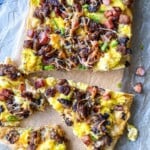 slices of breakfast pizza at a side angle