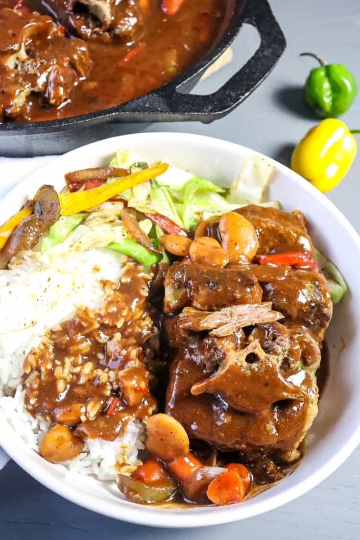 oxtails plated in a bowl with rice and cabbage