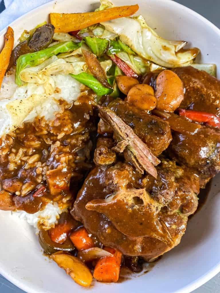 close up of plated oxtails with cabbage