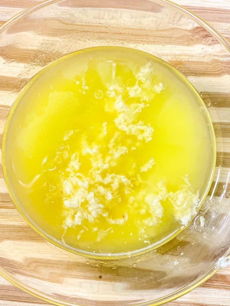 Grated Garlic in a bowl of melted butter