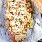 chicken bacon alfredo pasta in a bread boat