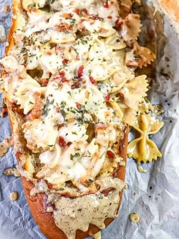 chicken bacon alfredo pasta in a bread boat