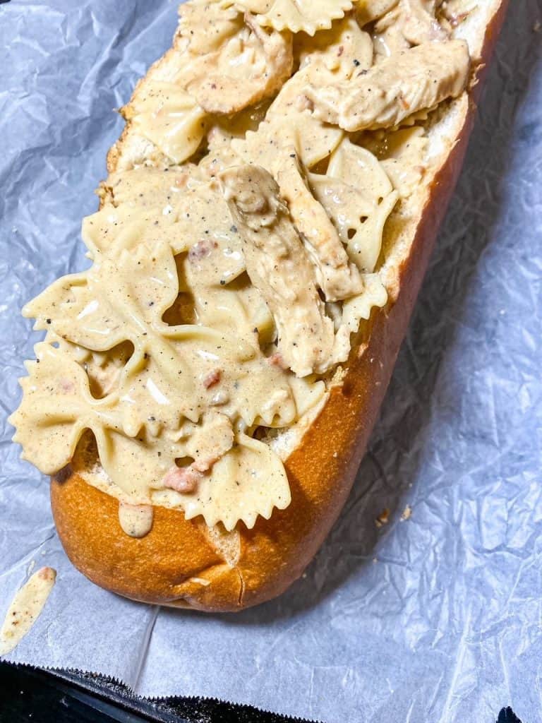 placed chicken alfredo into loaf of bread