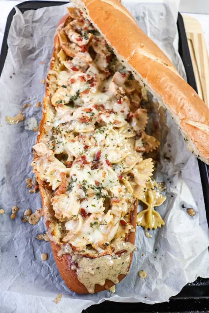overhead view of bowtie pasta with chicken and bacon served in a bread boat