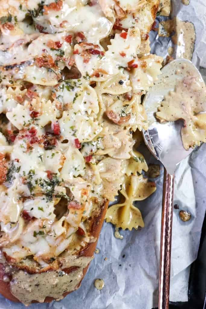 close up of pasta served in a loaf of bread