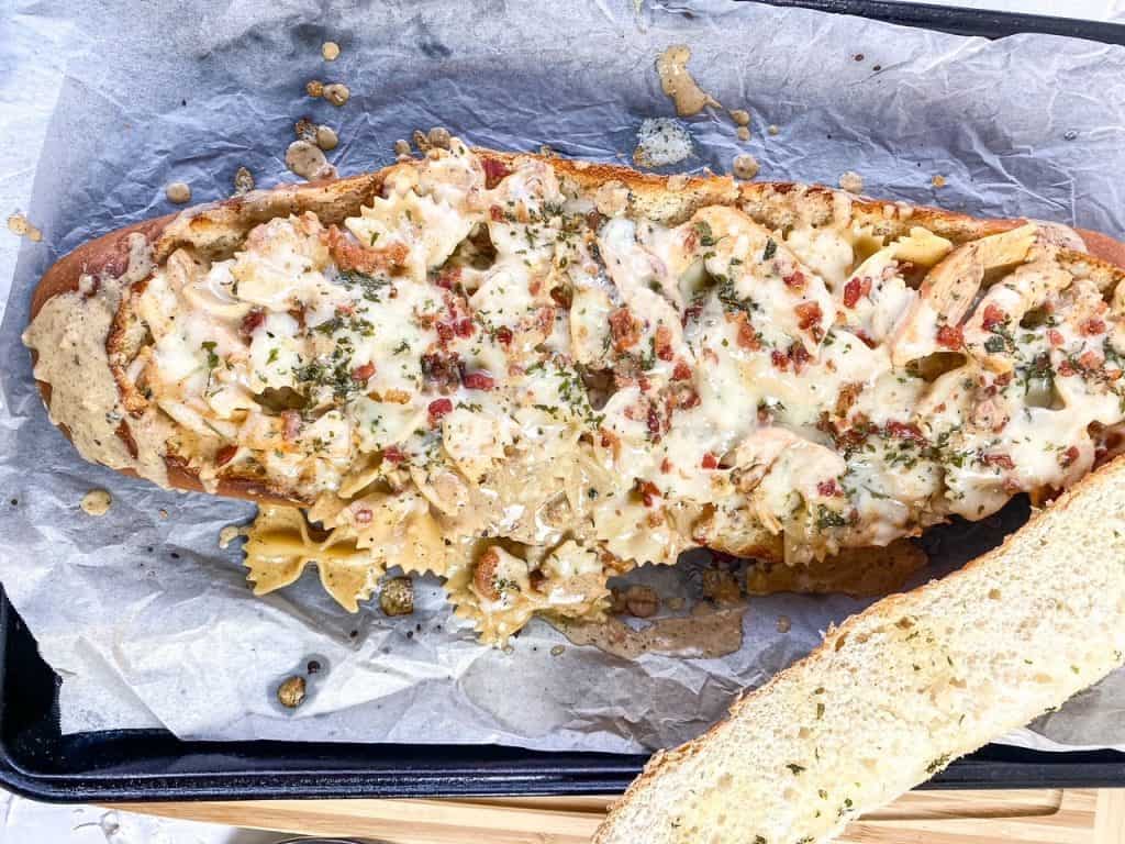 overhead view of chicken alfredo in bread boat