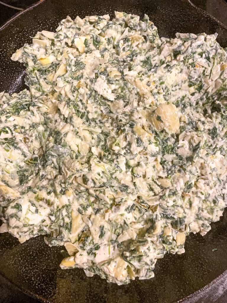spinach dip in the skillet as it is being prepped
