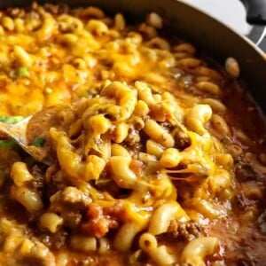 A big spoonful of Chili Mac and Cheese with a heaping pot of more behind it
