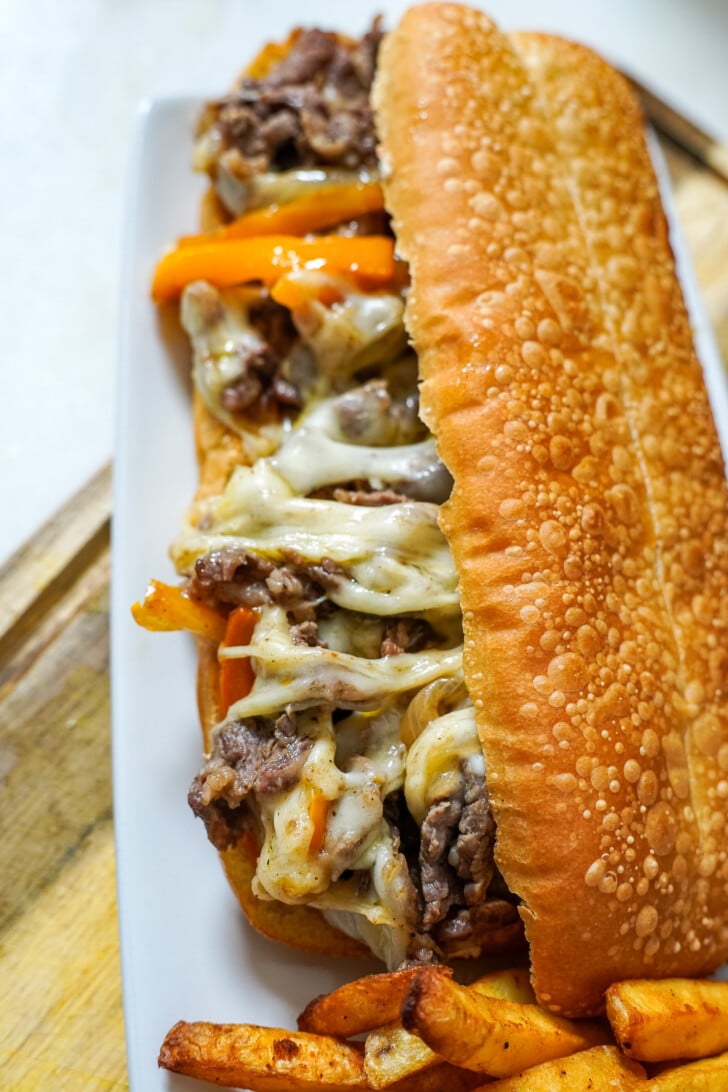cheesesteak sandwich on a white plate