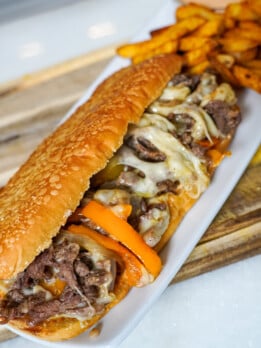 cheesesteak sandwich on a white plate