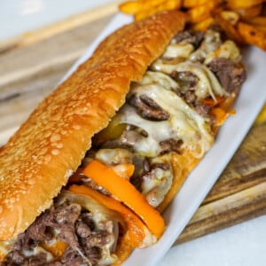 cheesesteak sandwich on a white plate