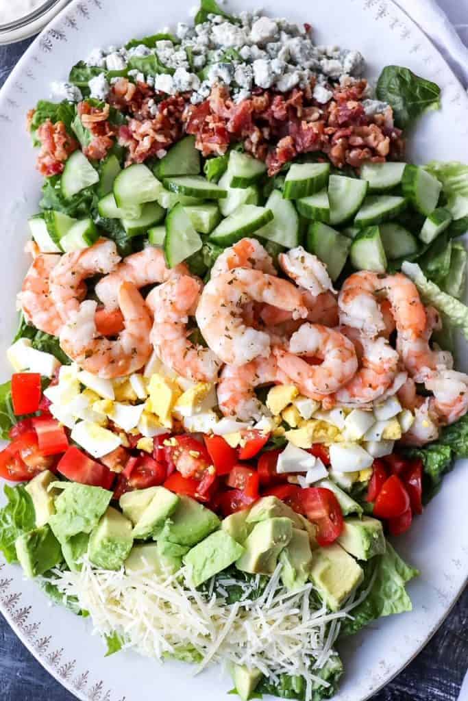 a platter of cobb salad with shrimp