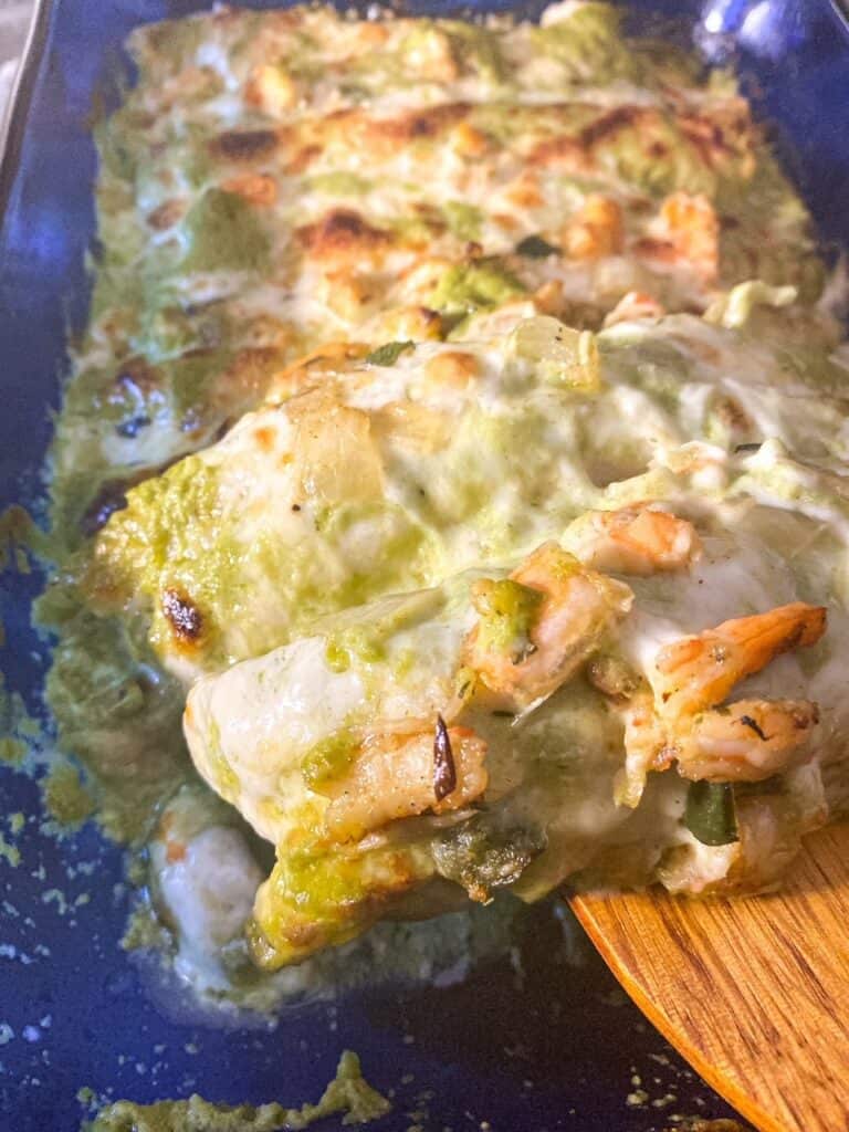 close up of shrimp enchiladas showing the cheese and shrimp