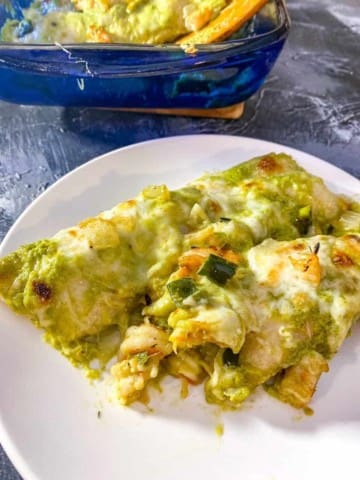 close up of shrimp enchiladas showing the cheese and shrimp