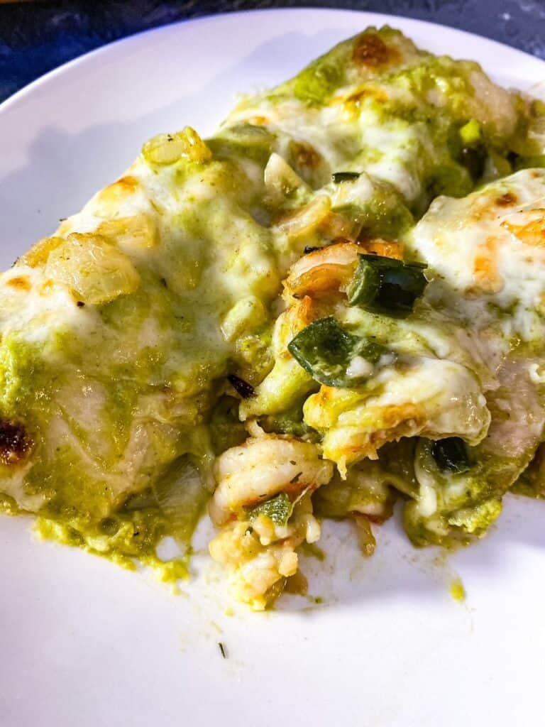 close up of shrimp enchiladas showing the cheese and shrimp