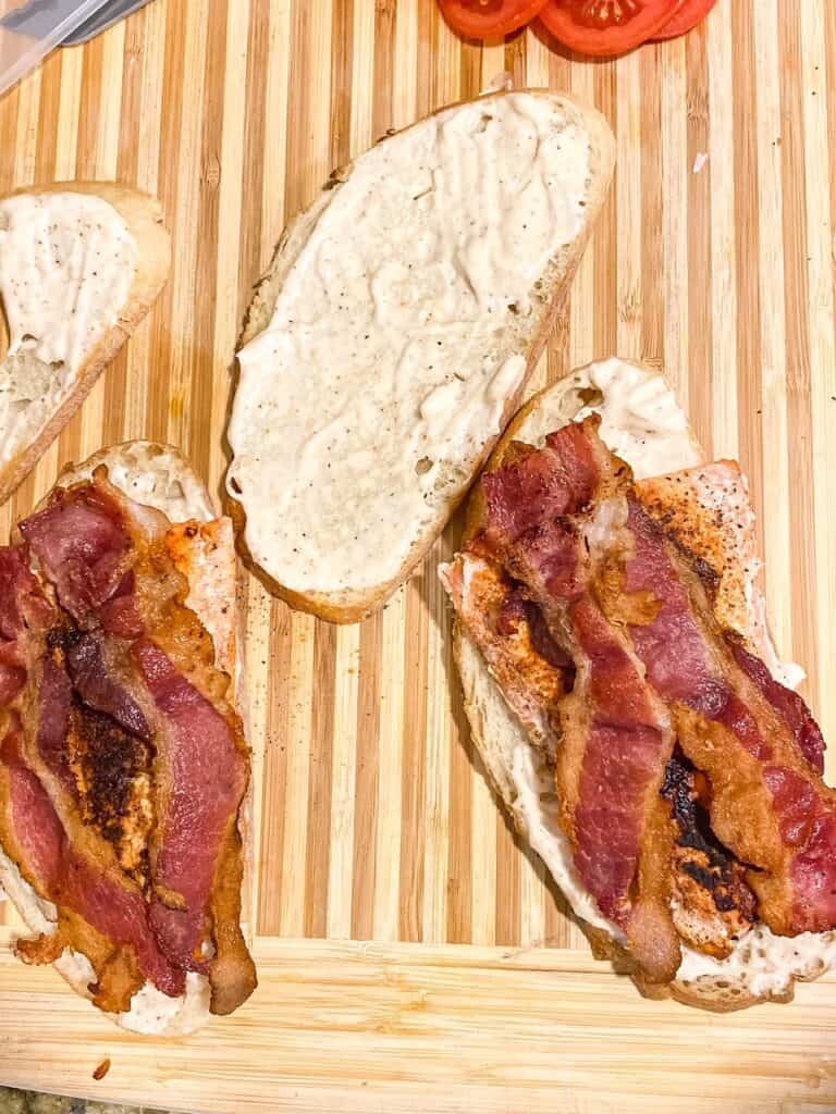 bacon and salmon on a piece of bread to make a salmon blt