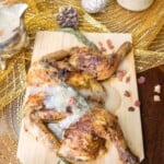 bacon gravy poured over a cornish hen on a board