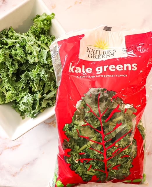 kale in a bowl with a bag of Nature's Greens sitting next to it