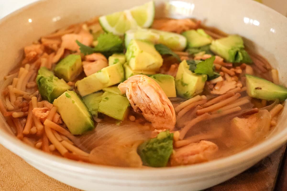 chicken lime avocado soup in a bowl close up 