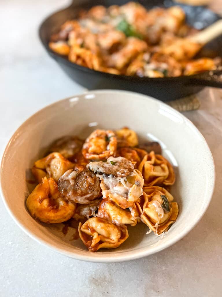 Italian sausage tortellini bake that has been portioned into a bowl 