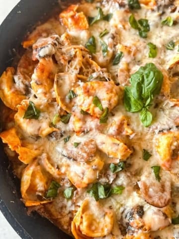 Italian sausage tortellini bake in a cast iron skillet