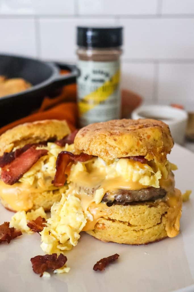 Two bacon, sausage, egg and cheese biscuits plated.
