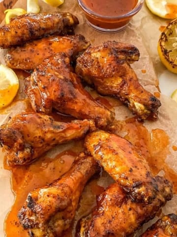 hot honey lemon pepper wings on parchment paper