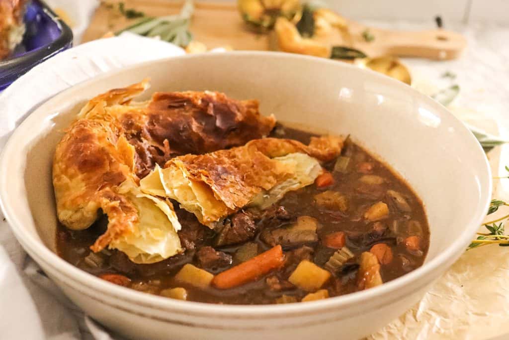 hearty beef and veggie pot pie in a bowl, close-up