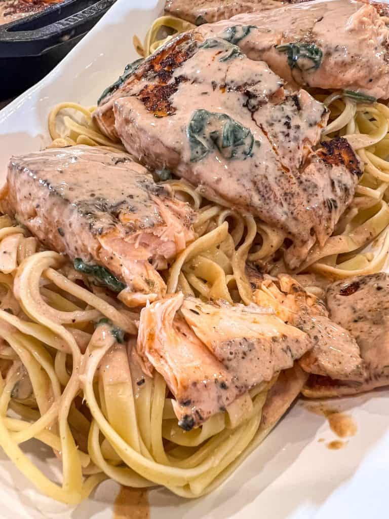 salmon over pasta in a bowl