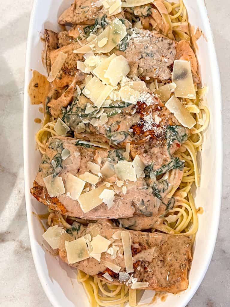 salmon over pasta with cheese on top